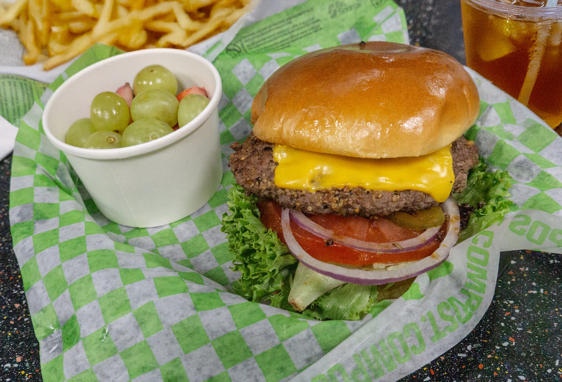 Cheeseburger basket with fries and fresh fruit from Arise Café
